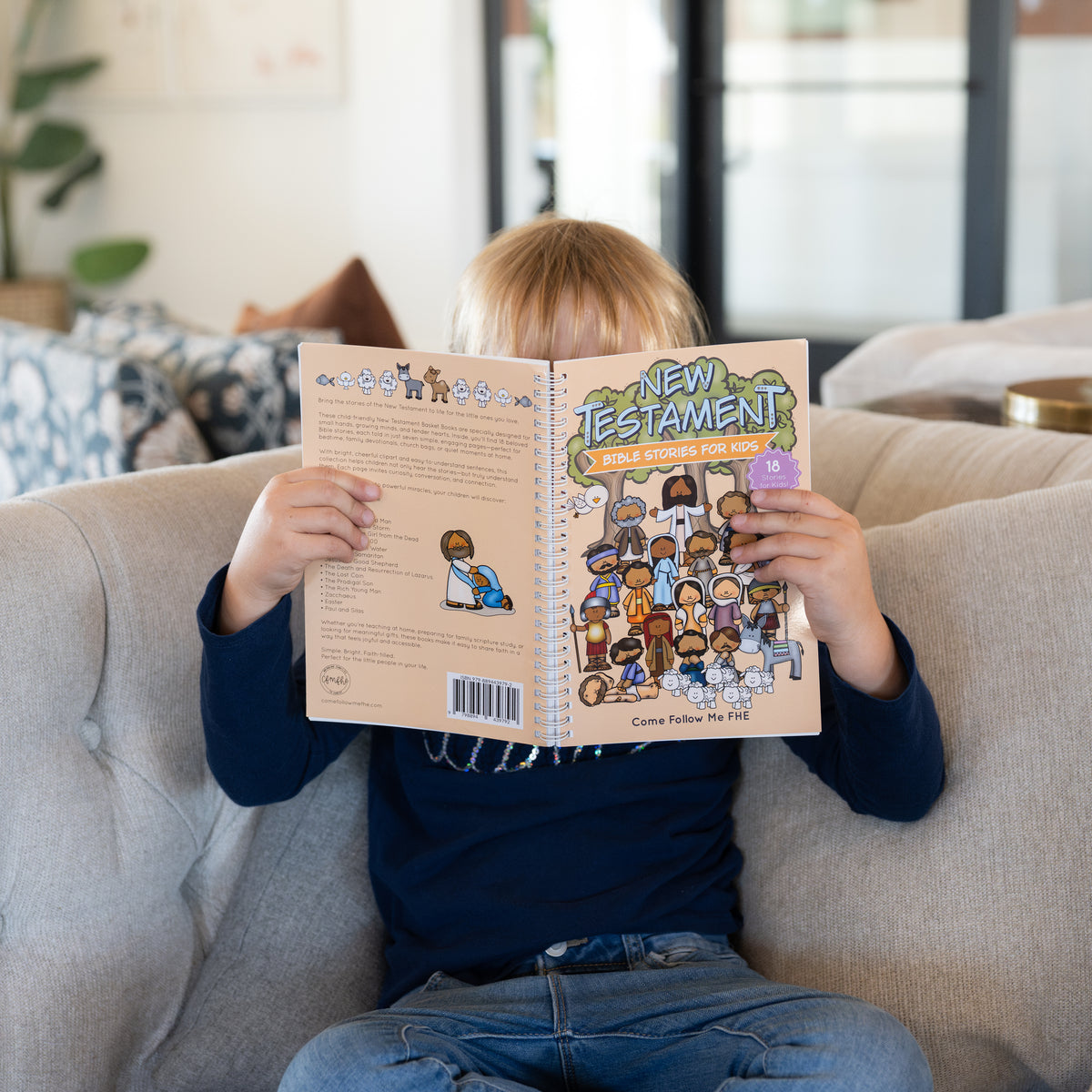 Child reading New Testament Bible Stories for Kids during family scripture study