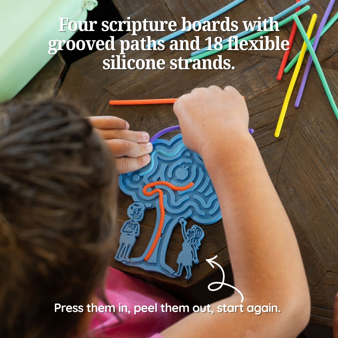 Close up of a child peeling a silicone strand out of the groove on a fidget board