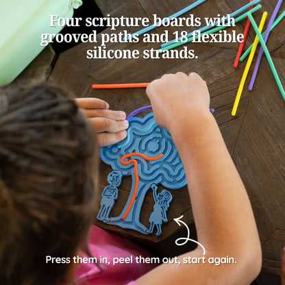 Close up of a child peeling a silicone strand out of the groove on a fidget board