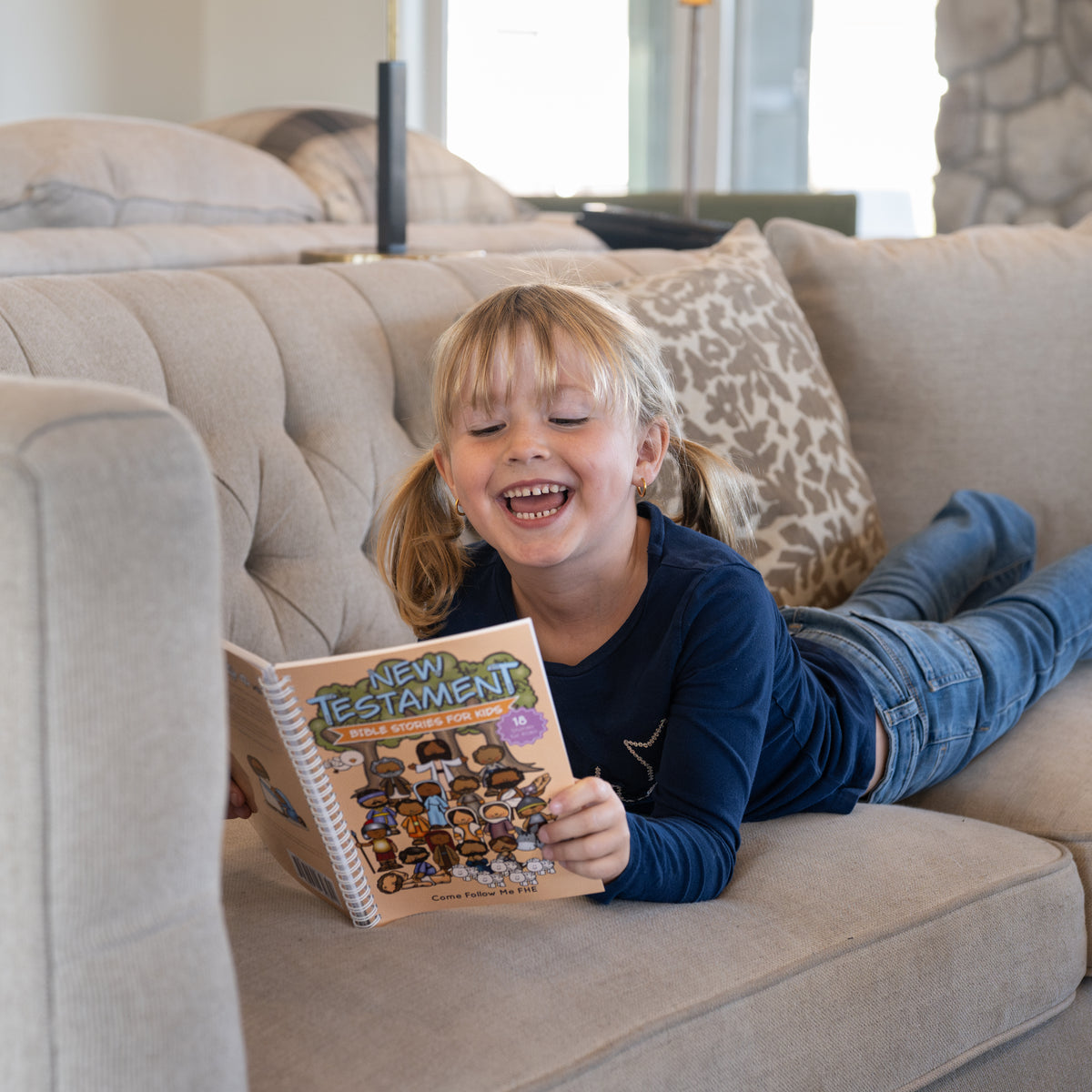 Child reading New Testament Bible Stories for Kids during family scripture study