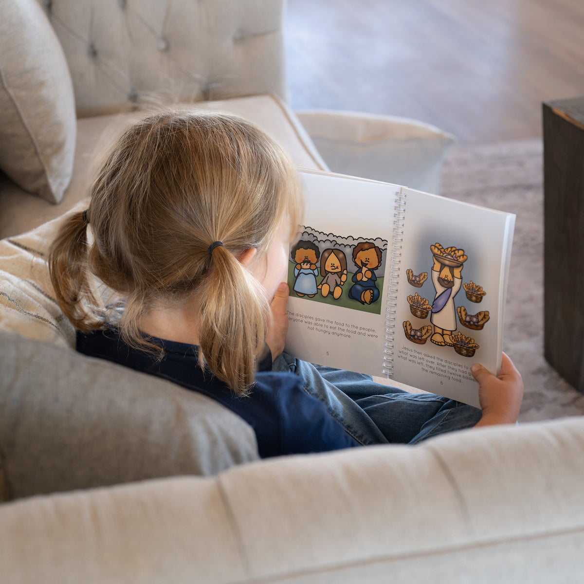 Child reading New Testament Bible Stories for Kids during family scripture study.